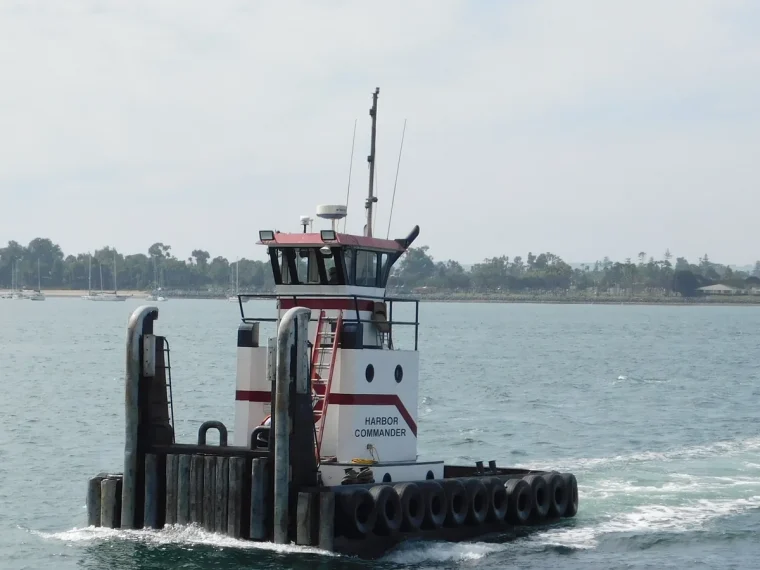 Working vessel and long shoreline across San Diego Bay